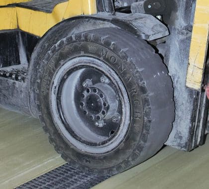 Image of a tire driving over structural fiberglass heavy duty pultruded grating.