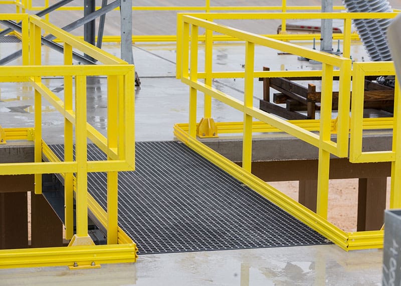 Fiberglass rectangular tube used in industrial frame structure near corrosive tank Fiberglass rectangular tube used in industrial frame structure near corrosive tank