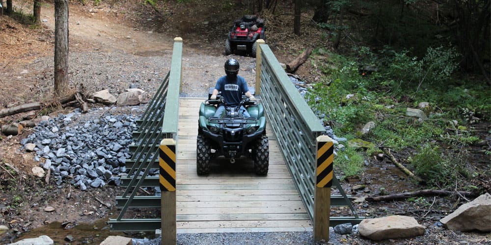 An ATV crossing a ReadySpan FRP bridge