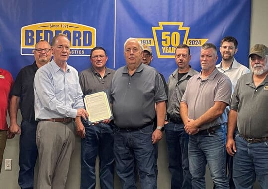 Group photo of Bedford employees celebrating 50 years in business.