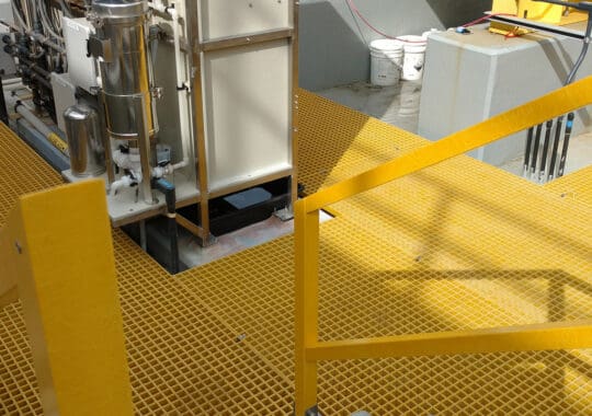 Yellow FRP platform and railings in industrial environment