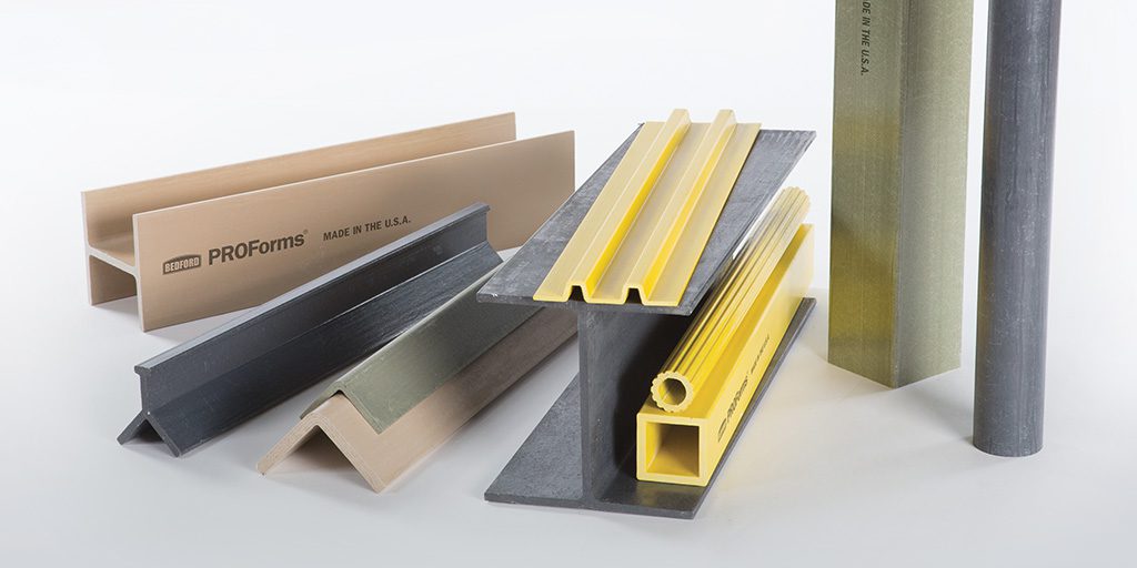 A variety of Bedford fiberglass composite materials are displayed, including profiles, rods, and tubes in different colors and shapes, highlighting their versatility.